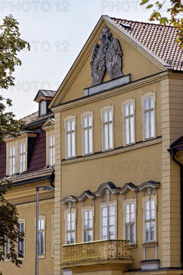 Detailed view of a baroque building with yellow façade, decorated pediment and windows, the façade of the Arnstadt Theatre in Thuringia