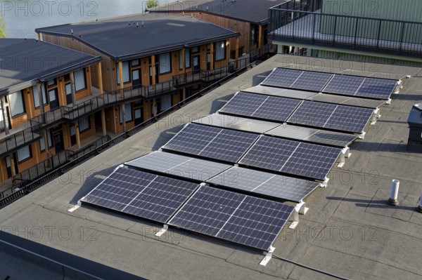Solar panels on roof of apartment building, renewable green sustainable energy concept, water cooling, aerial view, Gothenburg, Sweden