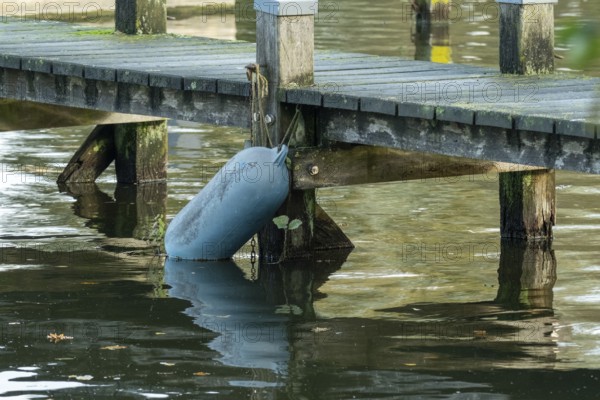 Borken, nrw, germany, buoy attached to old wooden dock over water, Borken, nrw, germany