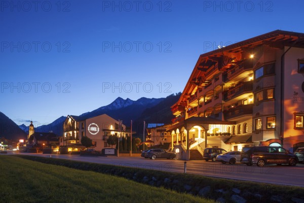 View of town with Hotel Stubaier Hof at dusk, Neustift im Stubai Valley, Stubai Valley, Stubai, Tyrol, Austria