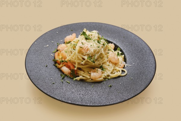 Delicious creamy garlic shrimp pasta is plated beautifully with fresh herbs and a sprinkle of cheese. This dish is perfect for a cozy dinner at home or entertaining guests