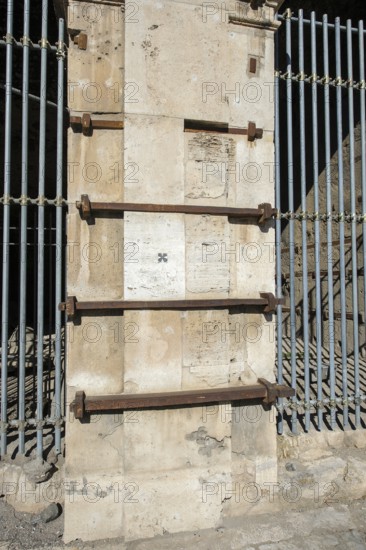 Pillar element made of travertine stone from Colosseum with architectural measure used in the construction of Amphiteatrum Flavium iron clips in masonry for stability strength cohesion, Rome, Lazio, Italy