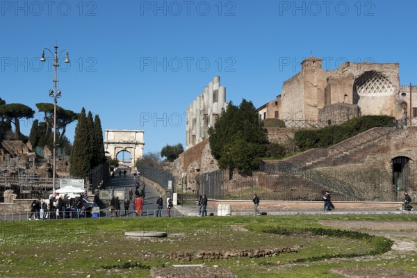 View of the foreground foundations remains of ancient fountains in Meta Sudan, behind Via Sacra and Arch of Titus, on the right ruin remains of columns and former cella of the Temple of Venus Temple of Venus Rome, Lazio, Italy