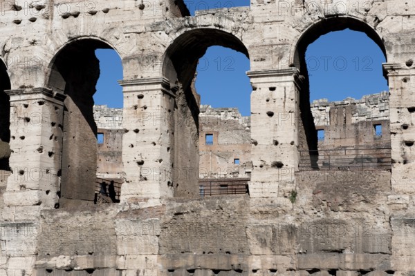 Part of façade with window arch in outer wall of Amphiteatrum Flavium Colosseum Colosseo in ancient center of Rome, Parco Archeologico del Colosseo, Archaeological Park at the Colosseum, Rome, Lazio, Italy