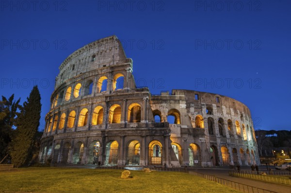 Night view photo in Blue Hour of Amphiteatrum Flavium Colosseum Colosseo in ancient center of Rome, Parco Archeologico del Colosseo, Archaeological Park at the Colosseum, Rome, Lazio, Italy