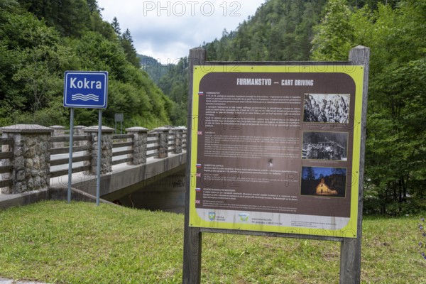 Information board with historical photos at the bridge over the Kokra River in the valley of Zgornja Kokra, Slovenia