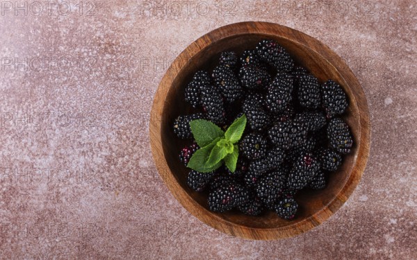 Blackberries, in a wooden bowl, top view, no people