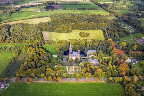 Aerial view, Moyland Castle Museum, neo-Gothic moated castle and castle park with herb garden surrounded by meadows and fields and autumn forest, tourist destination on the Lower Rhine, Moyland, Bedburg-Hau, Lower Rhine, North Rhine-Westphalia, Germany