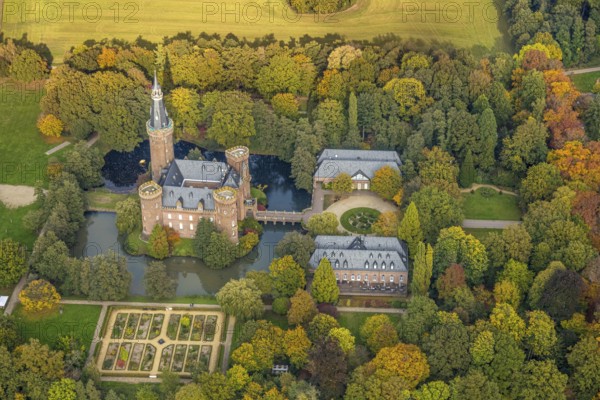 Aerial view, Moyland Castle Museum, neo-Gothic moated castle and castle park with herb garden, surrounded by meadows and fields and autumn forest, tourist destination on the Lower Rhine, Moyland, Bedburg-Hau, Lower Rhine, North Rhine-Westphalia, Germany