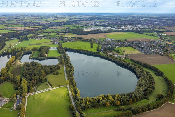 Aerial view, dark lake surrounded by autumn trees, town view Asperden, Goch, Lower Rhine, North Rhine-Westphalia, Germany, DE, Europe, aerial view, aerial photography, aerial photography, lake, overview, birds-eyes view, overview