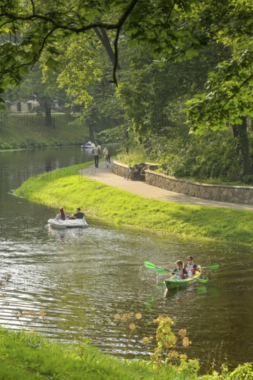 People, leisure, paddle boat, kayak, city canal, municipal park, Riga, Latvia