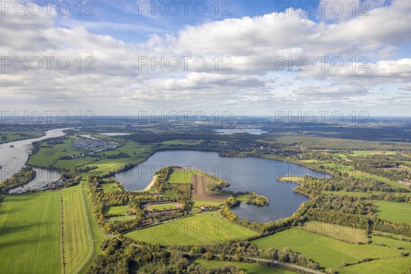 Aerial view, Auestadion Wesel, soccer stadium and athletics stadium surrounded by autumn trees, blue sky with clouds and distant views, in the back the Grav Island with campsite, Wesel, Lower Rhine, North Rhine-Westphalia, Germany, camping, camping area, motorhome, campsite, DE, Europe, leisure, soccer field, soccer stadium, grave island, hobby, aerial photography, aerial photography, side places, solar park, sports complex, sports field, grandstand, overview, bird's eye view, motorhome, caravan, birds-eyes view, overview