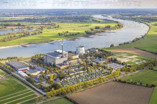 Aerial view, Kalkar Wonderland amusement park on the Rhine river with Rheinaue, Energy Factory, family park with events such as chain carousel in the cooling tower, rollercoaster and wild water ride and rides, hotel, convention center, gastronomy, Hönnepel, Kalkar, Lower Rhine, North Rhine-Westphalia, Germany, adventure, rollercoaster, attractions, excursion destination, visitors, DE, recreation, adults, Europe, rides, family park, river shore, leisure, leisure activities, amusement park, infrastructure, Kalkar Wonderland, children, landscape, aerial photography, aerial photography, travel, Rhine, summer, fun, daylight, theme park, tourism, overview, entertainment, events, bird's eye view, wild water ride, birds-eyes view, overview