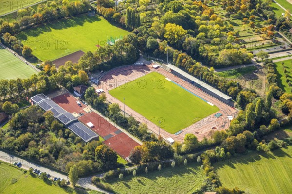 Aerial view, Auestadion Wesel, soccer stadium and athletics stadium, surrounded by autumn trees, building with solar roof, Wesel, Lower Rhine, North Rhine-Westphalia, Germany, DE, roof with solar panels, Europe, soccer field, soccer stadium, aerial view, aerial photography, aerial photography, side seats, photovoltaic system, solar roof, solar energy, solar panels, solar power sports complex, sports complex, sports field, grandstand, overview, bird's eye view, birds-eyes view, overview