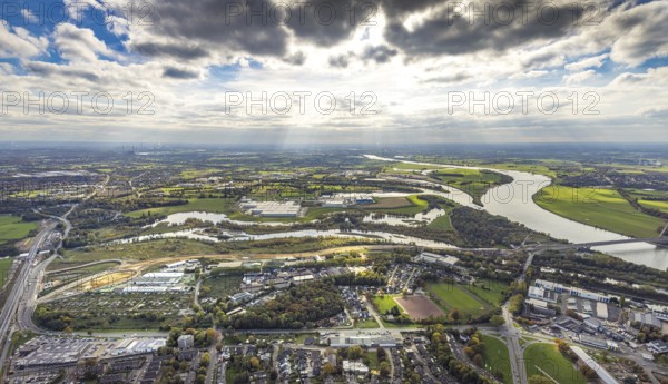 Aerial view, Lippe estuary with construction site, Lippe river and NSG nature reserve, Büdericher Insel, Rhine-Lippe harbour with Rhenus Logistics and Nordfrost GmbH, on the left the federal road B8 bridge at Lippeschlösschen in front the Am Lippeglacis industrial estate, blue sky with clouds, Wesel, Lower Rhine, North Rhine-Westphalia, Germany, Am Lippeglacis, construction, construction site, development, bridge, federal road B8, business, DE, Europe, river Lippe, riverbank, building, commercial area, port, trade, industry, infrastructure, landscape, Lippe estuary, Lippeschlösschen logistics, aerial photography, aerial photography, NSG, nature, nature reserve, Nordfrost GmbH, town view, perspective, Rhine-Lippe-Hafen, Rhenus Logistics, Ruhr area, protected area, urban planning, transport, overview, urban, traffic, traffic connection, bird's eye view, waterway, residential area, birds-eyes view, overview