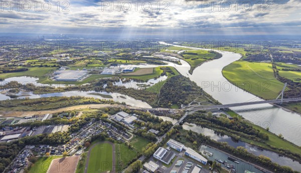 Aerial view, Lippe estuary with construction site, Lippe river and NSG nature reserve, Büdericher Insel, Rhine-Lippe harbour with Rhenus Logistics and Nordfrost GmbH, Rhine river and Wesel Lower Rhine bridge, blue sky with clouds, Wesel, Lower Rhine, North Rhine-Westphalia, Germany, Am Lippeglacis, construction, development, bridge, federal road B8, business, DE, Europe, Lippe river, riverbank, building, commercial area, port, trade, industry, infrastructure, landscape, Lippe estuary, Lippeschlösschen logistics, aerial photography, aerial photography, NSG, nature reserve, Nordfrost GmbH, town view, perspective, Rhine-Lippe-Hafen, Rhenus Logistics, Ruhr area, protected area, urban planning, transport, overview, urban, traffic, traffic connection, bird's eye view, waterway, residential area, birds-eyes view, overview