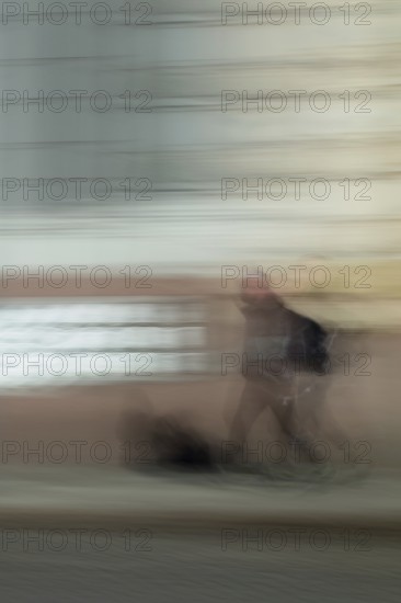 Abstract of a man walking in front of a building captured using ICM intentional camera movement technique, Helsinki, Finland