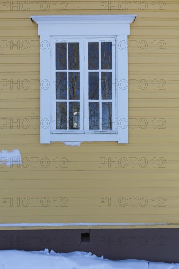 White framed wooden window on a yellow painetd wall, Suurikylä, Finland