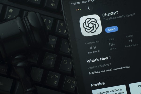 Dhaka, Bangladesh- 28 Oct 2025: An iPad displaying the ChatGPT app against a judge's gavel and dark keyboard background