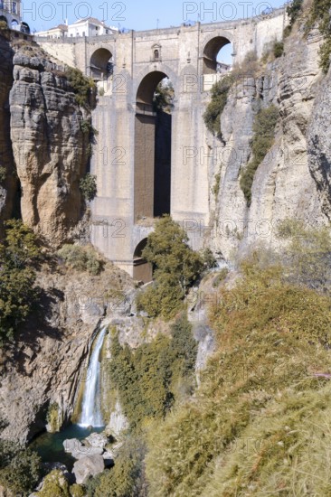 Ronda, malaga, spain Puente nuevo bridge connecting the historic and modern parts of ronda. Waterfall cascading in el tajo gorge