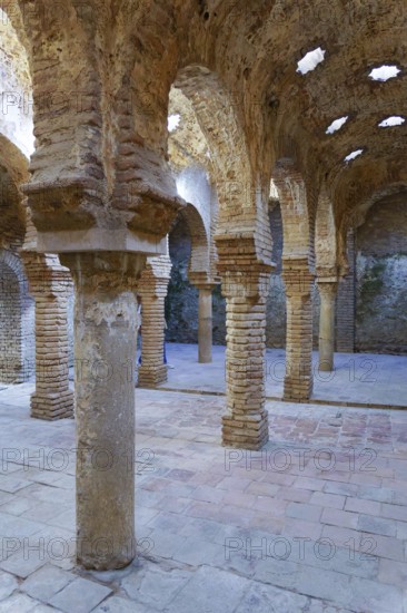 Ronda, malaga, spain Ancient moorish architecture with brickwork arches, columns, and star-shaped openings in the historic arab baths
