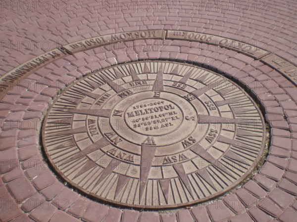 The geographic azimuth at Victory Square is located in the city. Directions to different points of the world emanate from it, along with longitude and latitude coordinates, as well as distances to major cities such as Moscow, St. Petersburg, and Tokyo. The center of the circle indicates the founding date of Melitopol, as of 2009, it was 225 years since its founding. It is a well-known landmark for both tourists and travelers. Melitopol, Ukraine