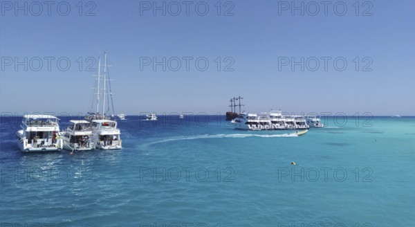 The snow-white yachts arrived as part of the Egyptian Maldives excursion tour, dropping off travelers and tourists on the heavenly White Island, where they can go diving and snorkel in the azure, turquoise, and crystal-clear, aquamarine waters of the Red Sea, admiring the tropical underwater inhabitants. A heavenly place where tourists can experience indescribable emotions. Middle East. Egypt