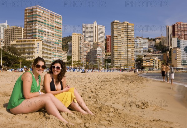Two woman wearing big sunglasses on the beach, Benidorm, Valencia (region), Costa Blanca, Spain