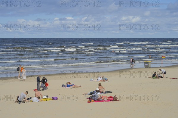 People on sandy beach, Baltic Sea, waves, Jurmala, Latvia