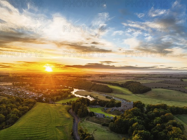 Sunset over Norham Castle and River Tweed from a drone, Norham, Northumberland, England, United Kingdom