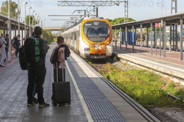 Renfe Civia commuter train at platform of Airport railway station, Rodalia de Barcelona suburban rail network, Barcelona, Catalonia, Spain
