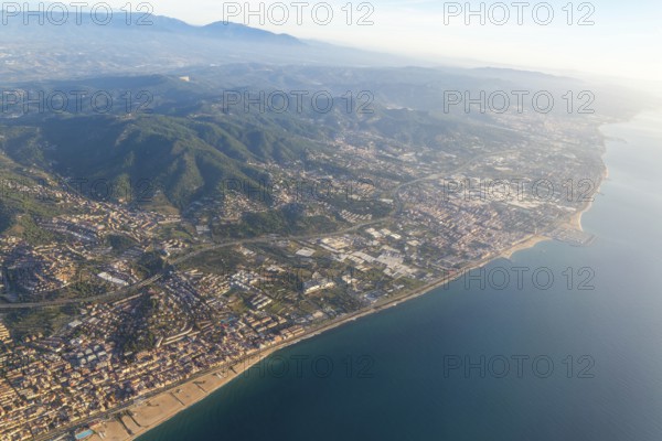 Oblique aerial view of settlements on coastal plain and hillsides, Mediterranean Sea coast, El Masnou, Barcelona, Catalonia, Spain