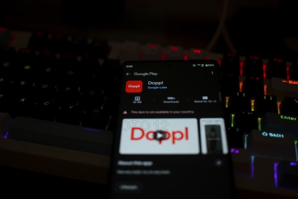 Smartphone displaying Doppl app on Google Play in front of a lit keyboard