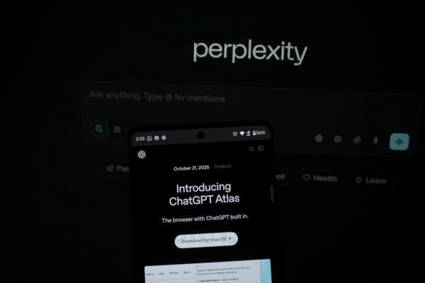 Smartphone screen with ChatGPT Atlas text against a background labeled perplexity