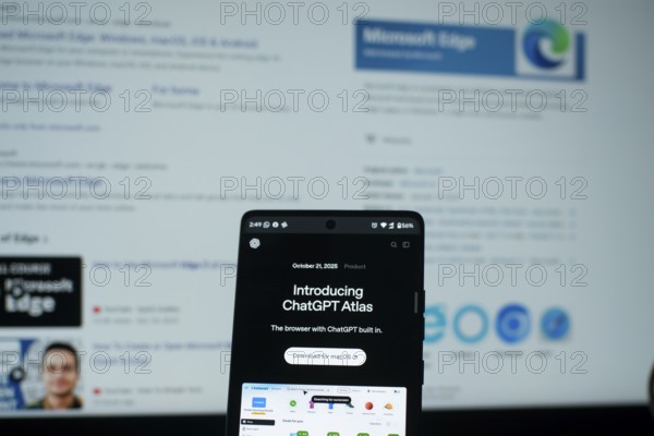 ChatGPT Atlas on a phone with Microsoft Edge search results in the background
