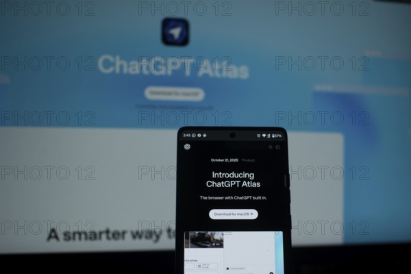 A smartphone highlighting ChatGPT Atlas in front of a blue screen