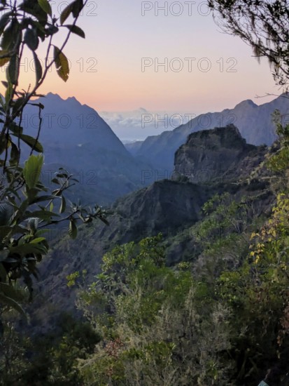 Sunset view over rugged mountains and a valley with a colorful sky, La Réunion, France