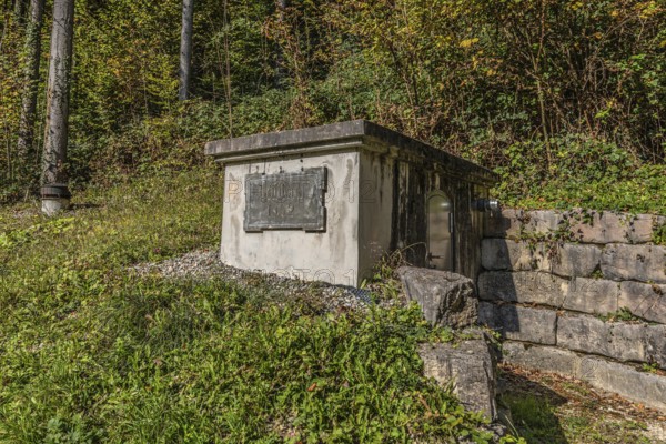 Water reservoir with the inscription Böttstein 1902 of the artificially created water channel that used to drive the historic oil mill and sawmill in Böttstein. Böttstein, Aargau, Switzerland