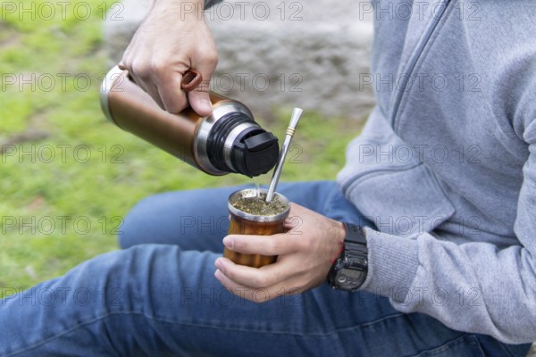 The process of cebar mate: young person preparing the south american infusion
