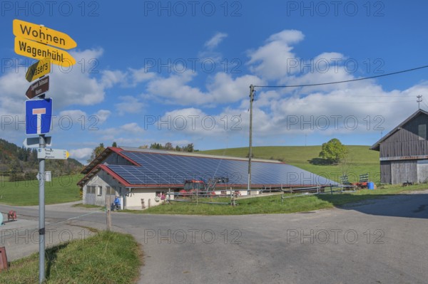 Blue sky with clouds, solar panels on barn roof near Kempten, Swabia, Bavaria, Germany