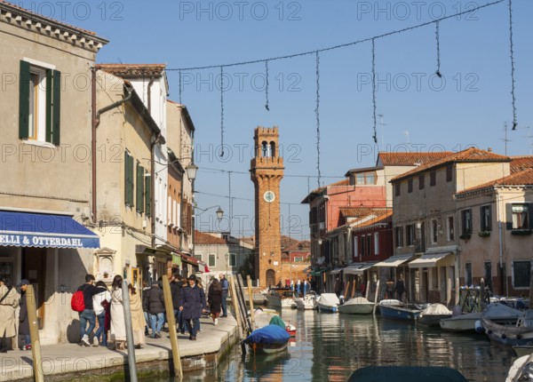 Clock tower and canal on island Murano, Venice, Italy