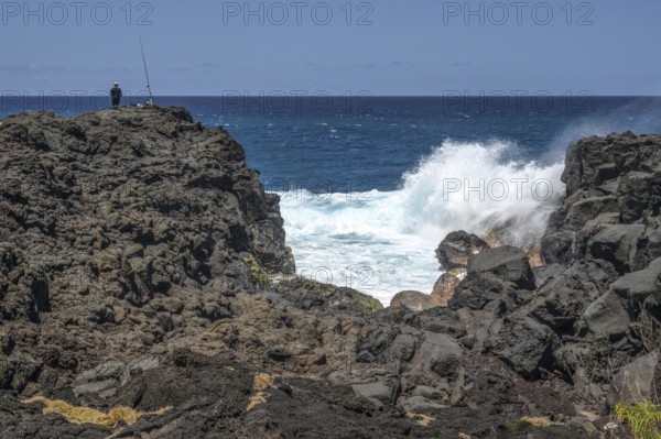 Thundering surf washes around the black lava cliffs of the south coast of the Indian Ocean, very close to the Marine de Vincendo car park, south coast, La Reunion, France