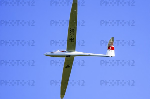 A DG Flugzeugbau glider DG-1000, registration HB-3361, during a demonstration as part of an air show at the Fliegerbergfest of the Rossfeld Luftsportverein in Metzingen-Glems, Baden-Württemberg, Germany, for editorial use only