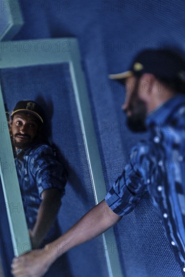 EDITORIAL and NEWS ONLY, celebrity and stand-up comedian Matt Okine looking at himself in mirror backstage with introspective self-perception a few minutes before his stage gig performance in Adelaide, Australia