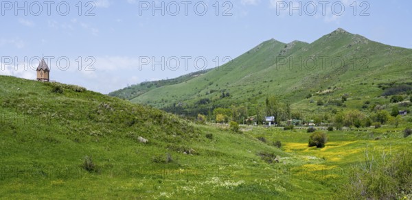 Small church on a green hill in front of picturesque mountains and blooming meadows, church, Jermuk, Jermuk, Vayots Dzor province, Armenia