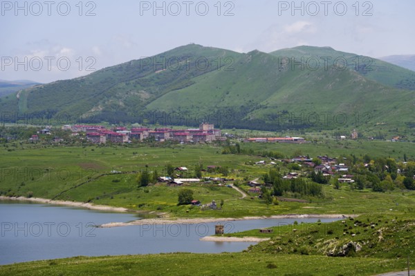 Village in green hills with lake and mountains in the background, Kechut, Kushchi, Kush-Bilyak, and Kechut Reservoir, Wajoz Dzor Province, Vayots Dzor, Armenia