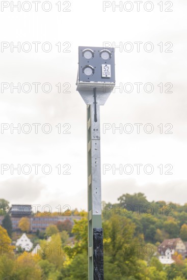Camera pole in front of autumn landscape with trees and buildings in the distance, Signalbau an der Hermann Hessebahn, Calw, Germany