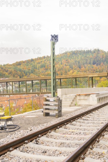 Railway tracks in autumn with a high pole next to them, Signalbau an der Hermann Hessebahn, Calw, Germany