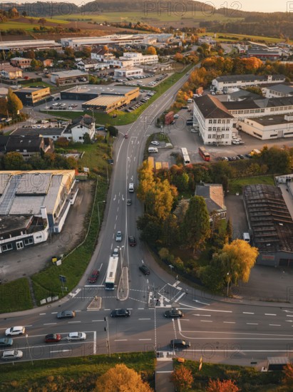Traffic on roads through an industrial area surrounded by autumn trees, Calw, Black Forest, Germany