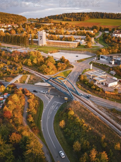 Aerial view of a bridge over Hermann Hesse railway tracks surrounded by autumnal landscapes, Calw, Black Forest, Germany